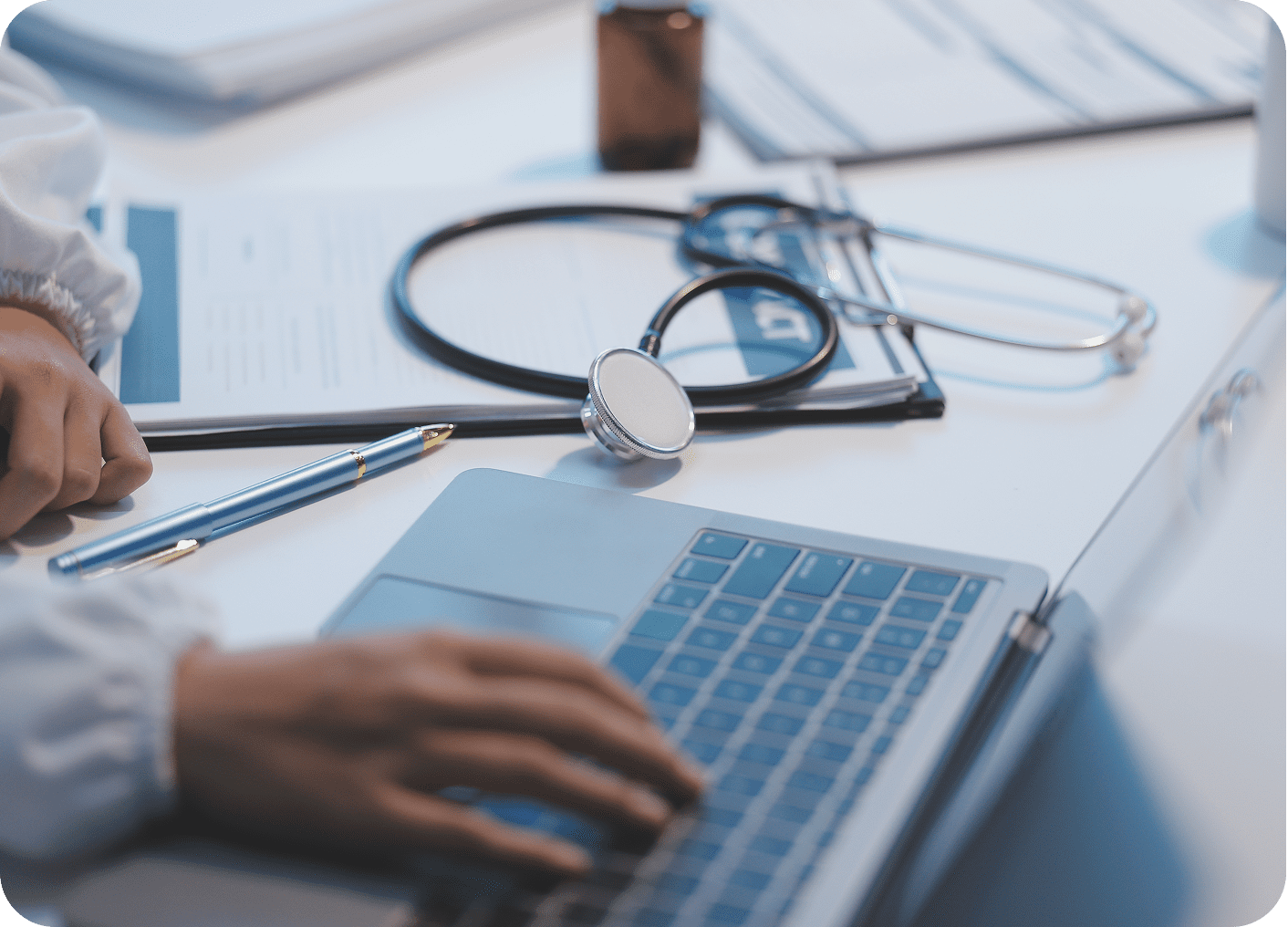 Doctor working at desk with laptop