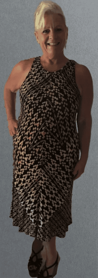Woman in patterned dress smiling